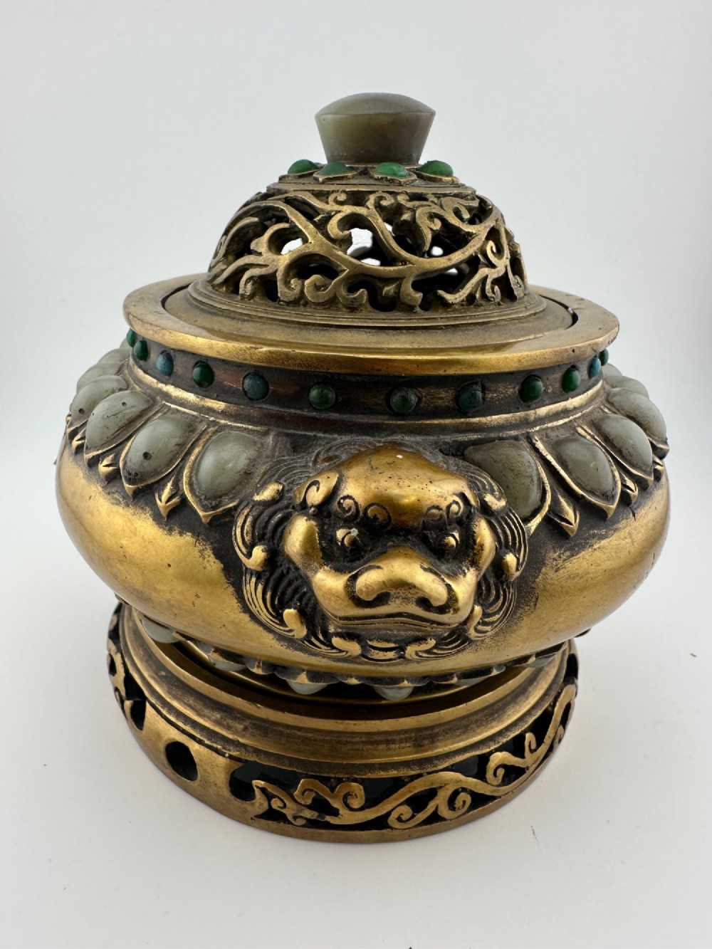 An antique gilded bronze Chinese censer featuring hardstone and jade cabochon inlays, beast-head handles, a pierced cover, and a matching carved stand. View IV