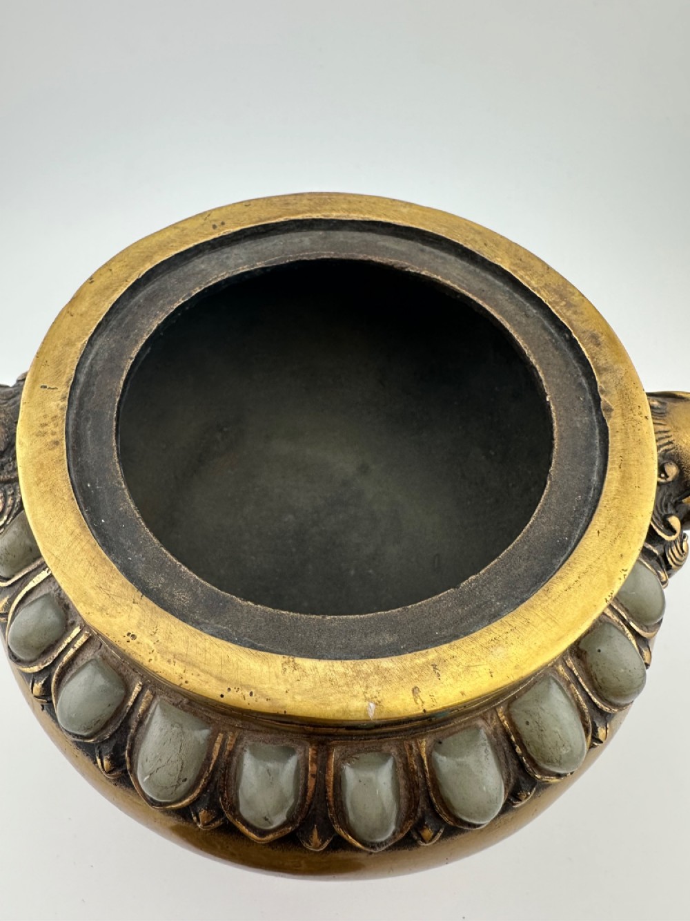 An antique gilded bronze Chinese censer featuring hardstone and jade cabochon inlays, beast-head handles, a pierced cover, and a matching carved stand. View VII