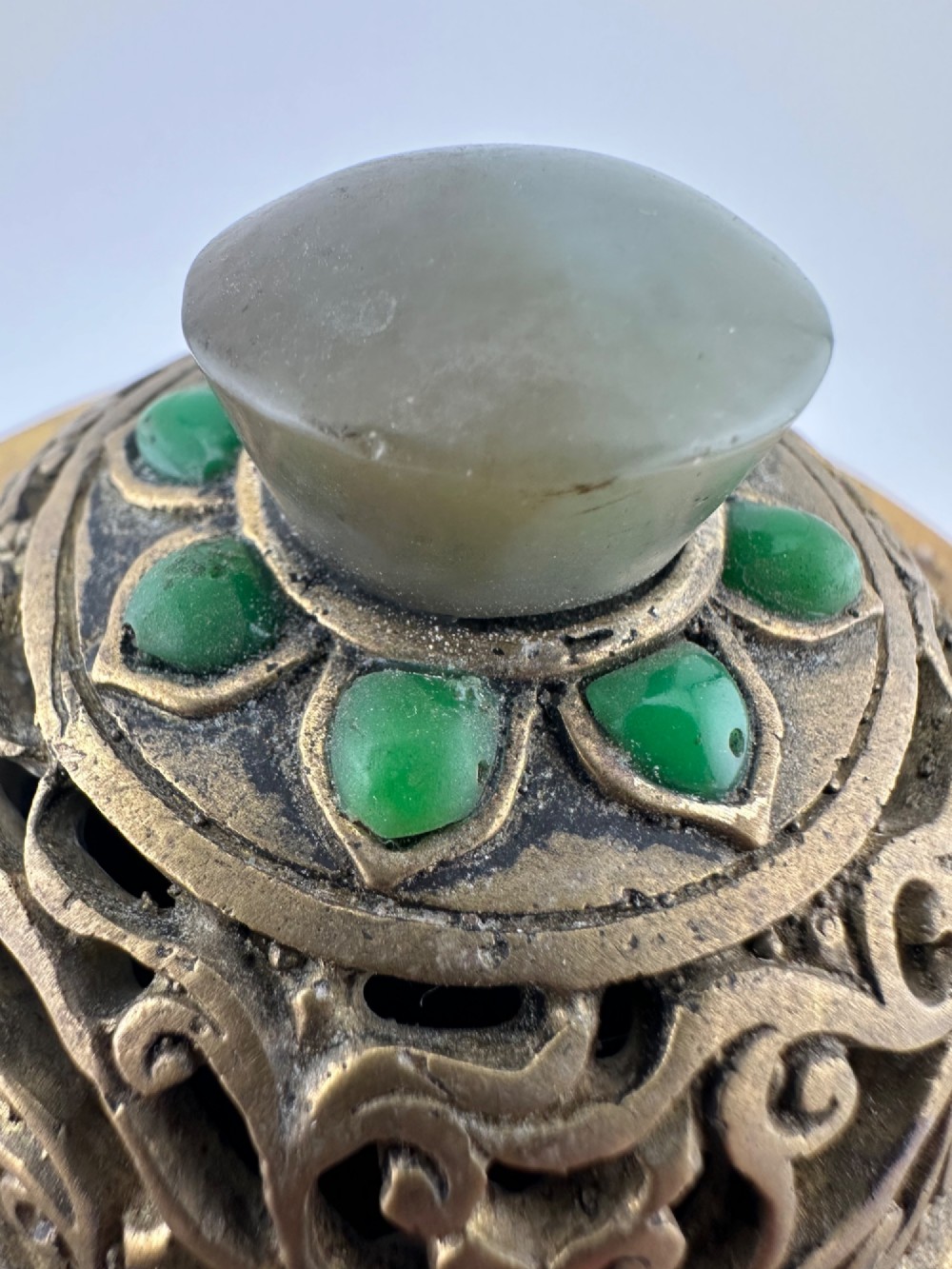 An antique gilded bronze Chinese censer featuring hardstone and jade cabochon inlays, beast-head handles, a pierced cover, and a matching carved stand. View IX