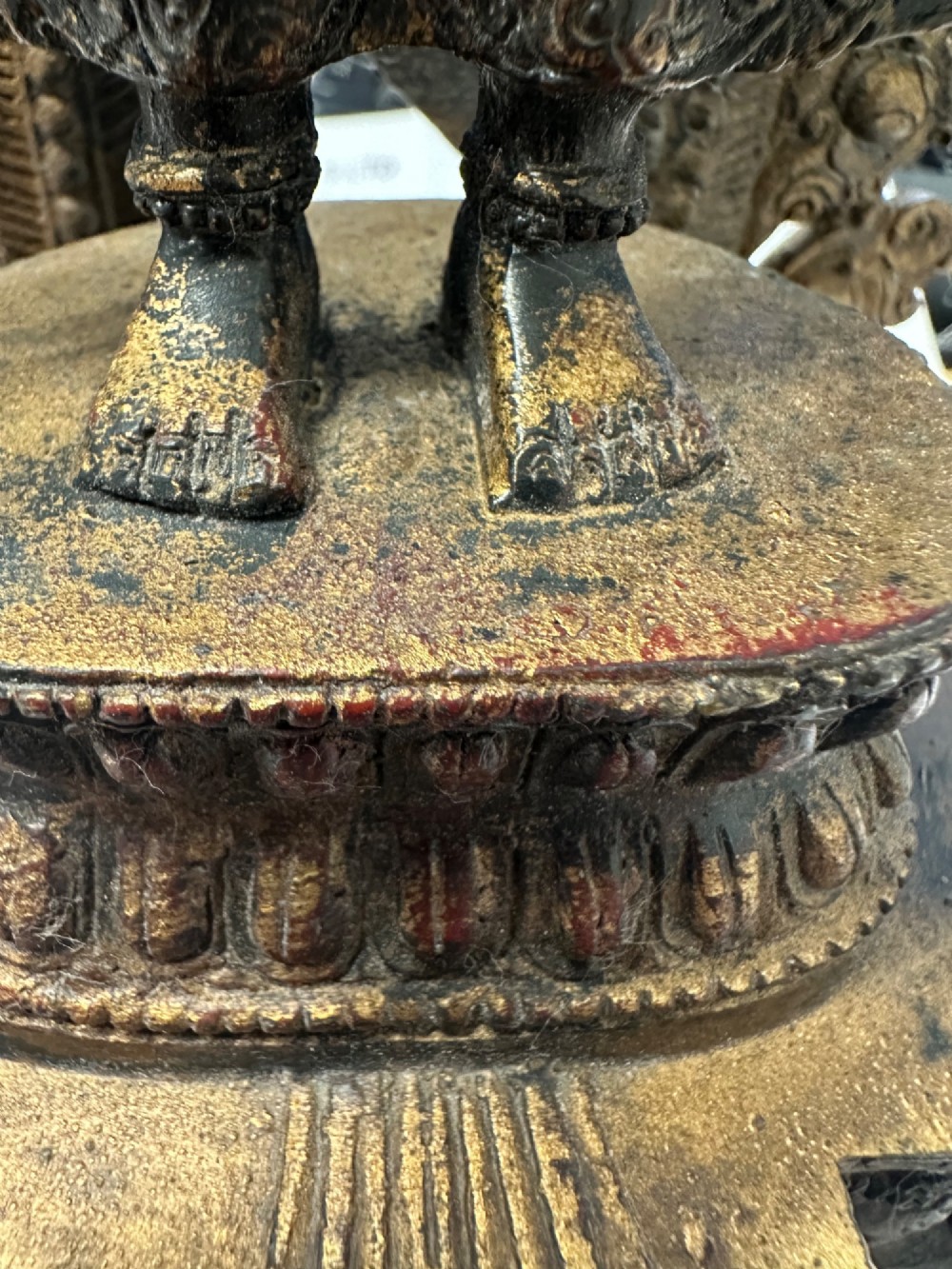 A dark bronze Tibetan sculpture depicting eleven-headed Avalokiteshvara with radiating arms set against a halo mandorla on a lotus pedestal. View X