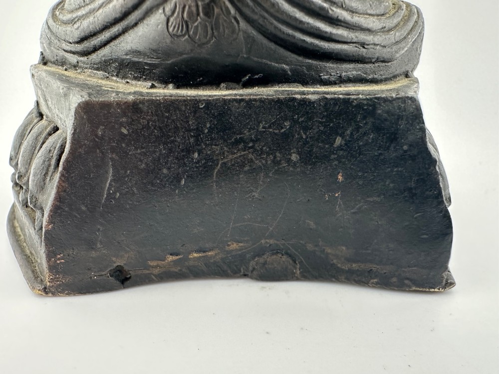 A dark bronze figure of the Buddhist deity Tara seated in lalitasana on an ornate lotus base. View VIII