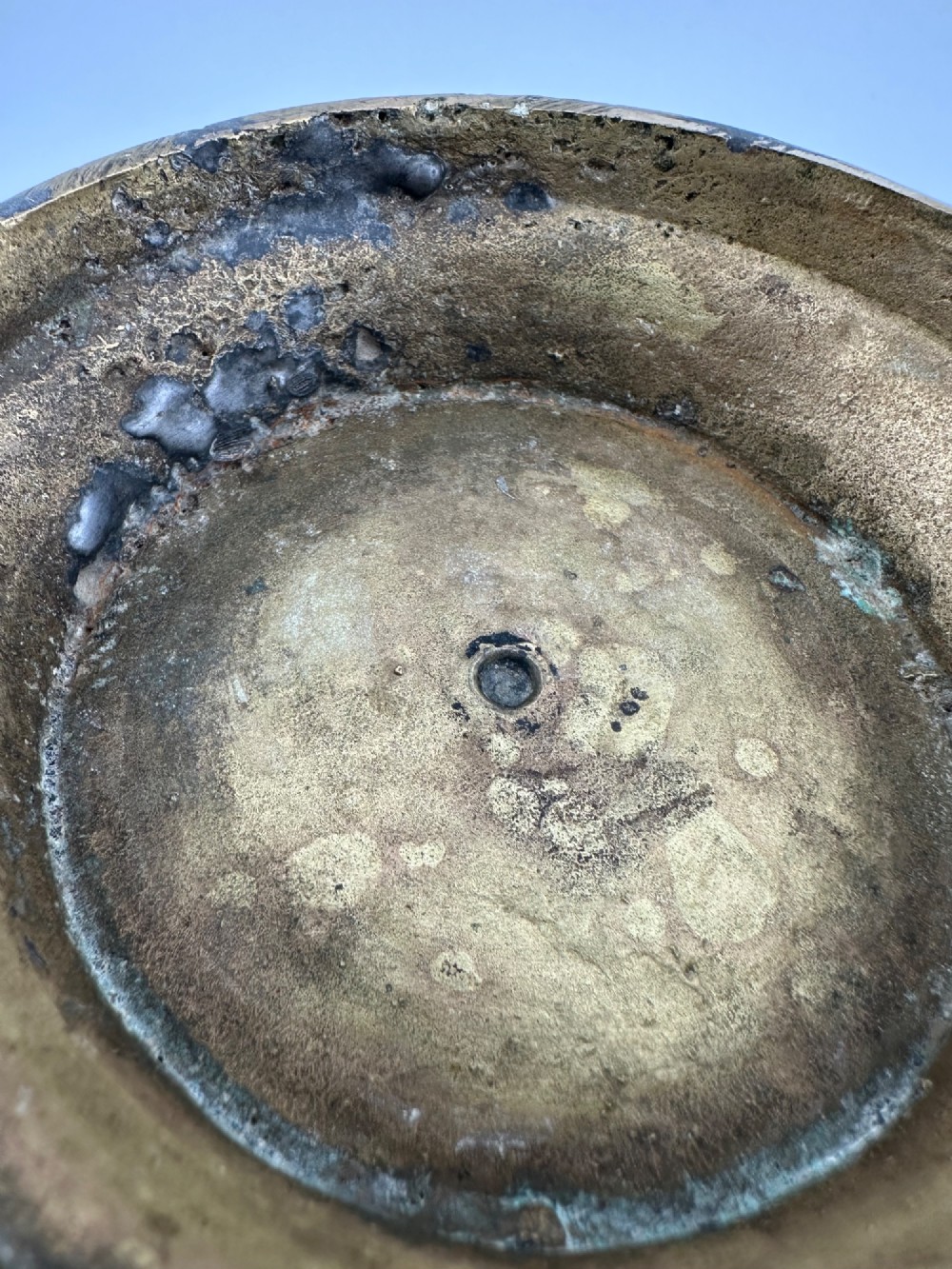 A rounded antique brass Chinese censer featuring a flared rim, pedestal base, and sculpted lion mask handles on either side. View IX