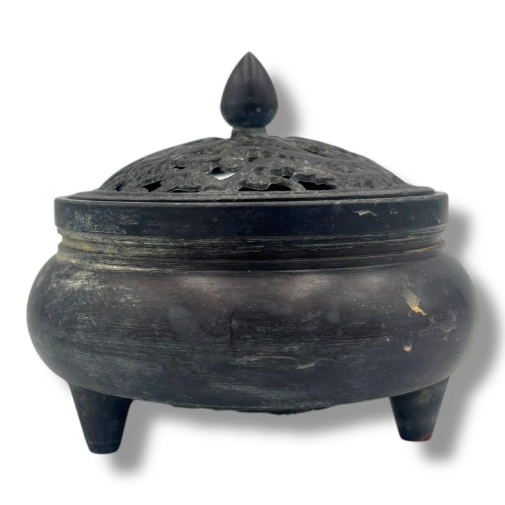 A dark patinated bronze tripod censer featuring a rounded body, three short tapered feet, and a pierced openwork lid topped with a bud finial. View IV