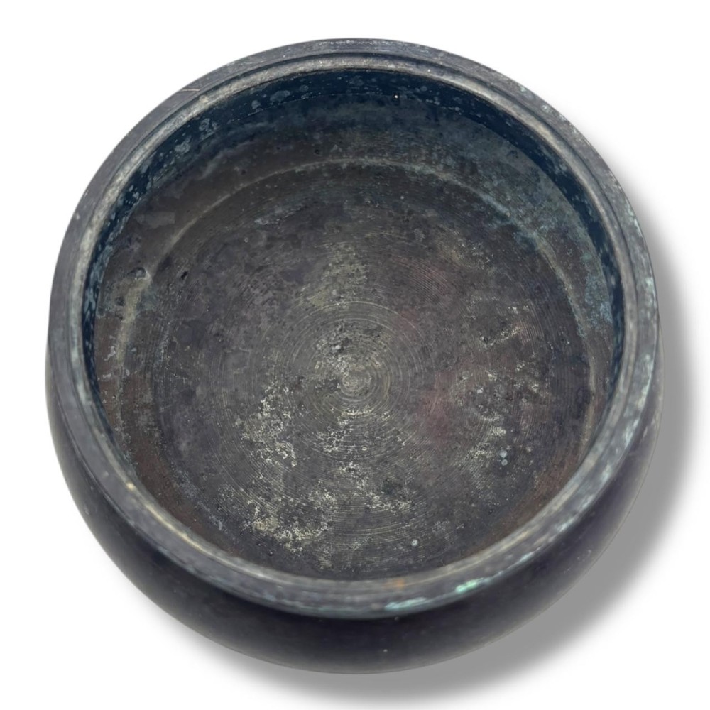 A dark patinated bronze tripod censer featuring a rounded body, three short tapered feet, and a pierced openwork lid topped with a bud finial. View V