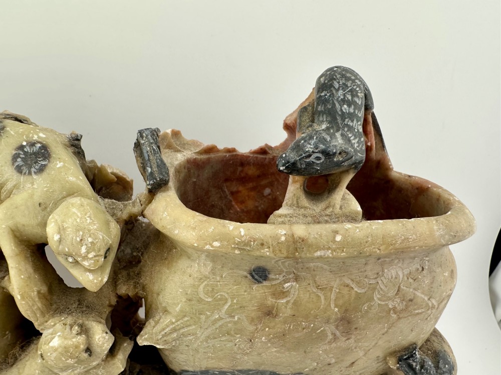 An antique Chinese carved soapstone double brush washer featuring two vessel shapes supported by carved animals and pierced rockwork in shades of mottled green, cream, and dark grey. View IV
