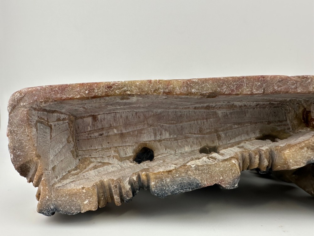 An antique Chinese carved soapstone double brush washer featuring two vessel shapes supported by carved animals and pierced rockwork in shades of mottled green, cream, and dark grey. View VIII