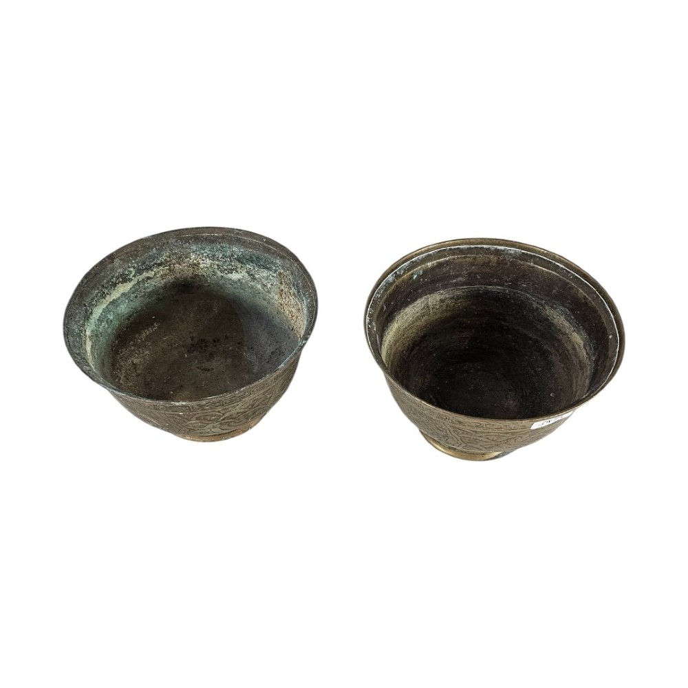 A pair of antique Chinese cast bronze footed bowls decorated with etched bird and lotus leaf motifs beneath key-fret rim borders. View II