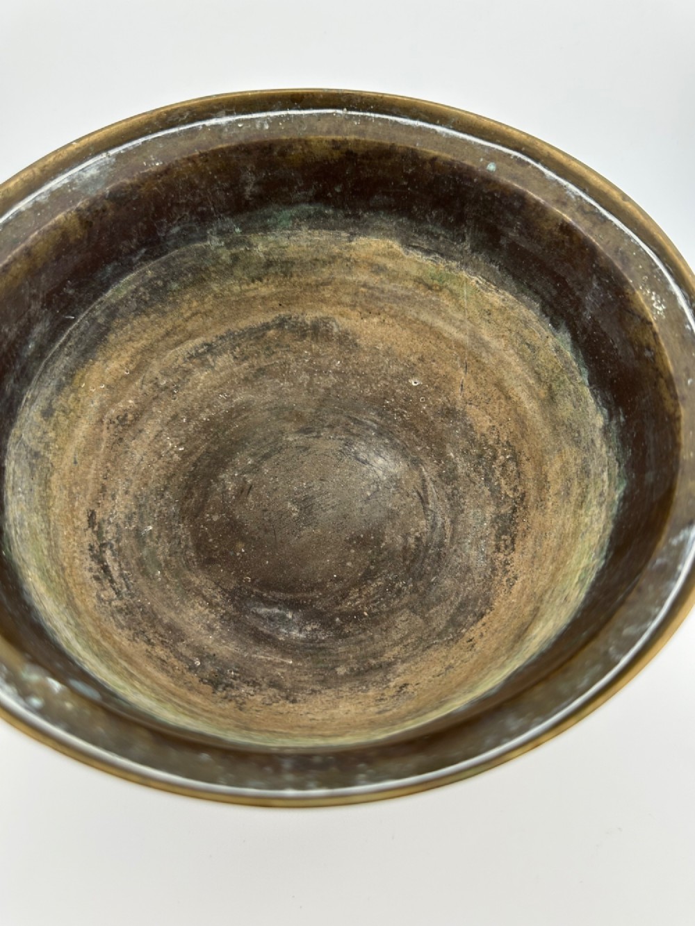 A pair of antique Chinese cast bronze footed bowls decorated with etched bird and lotus leaf motifs beneath key-fret rim borders. View V