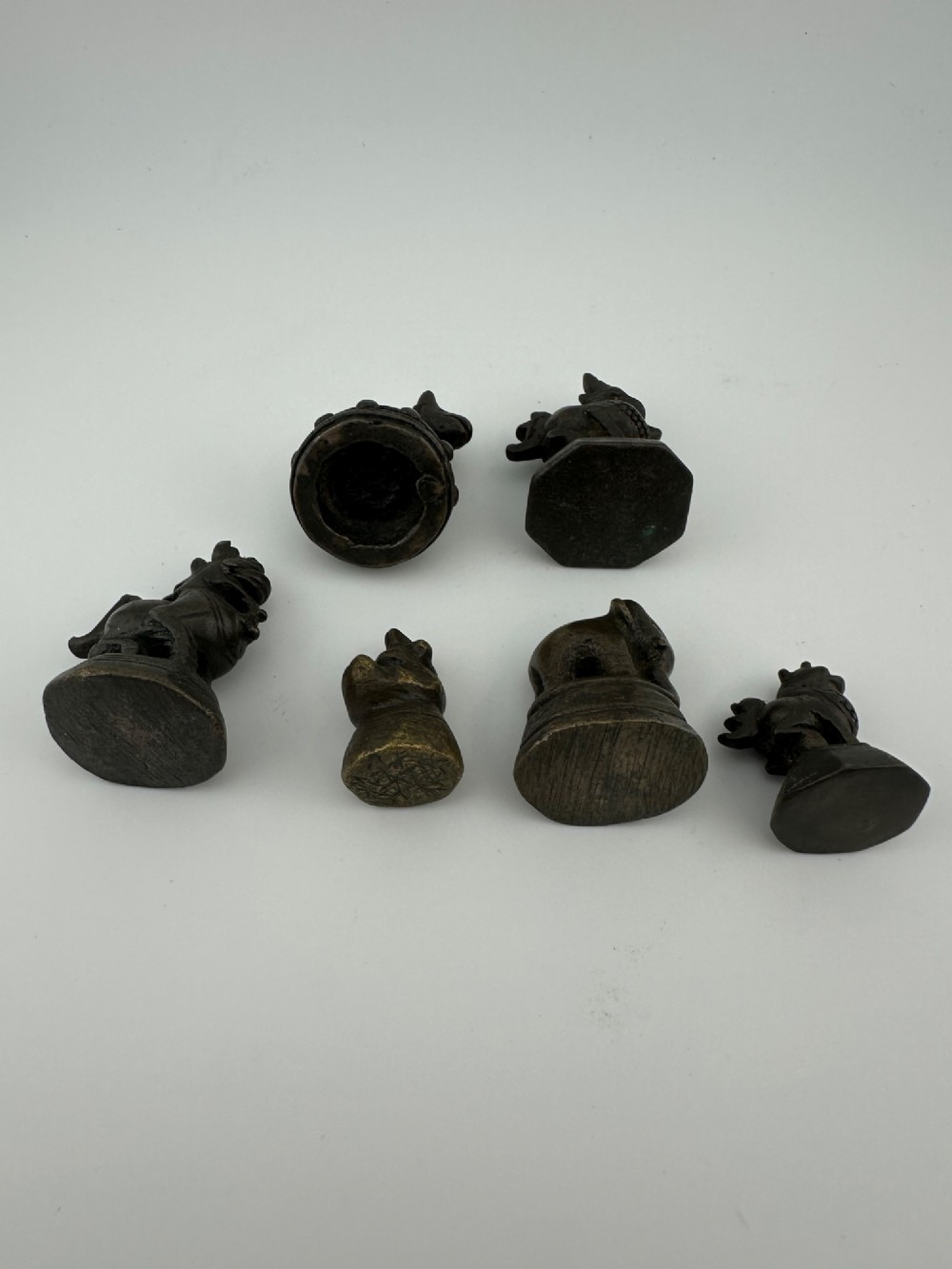 A set of six dark bronze zoomorphic trade weights depicting various animals mounted on octagonal and circular pedestals. View III