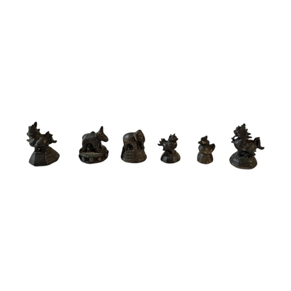 A set of six dark bronze zoomorphic trade weights depicting various animals mounted on octagonal and circular pedestals. View X