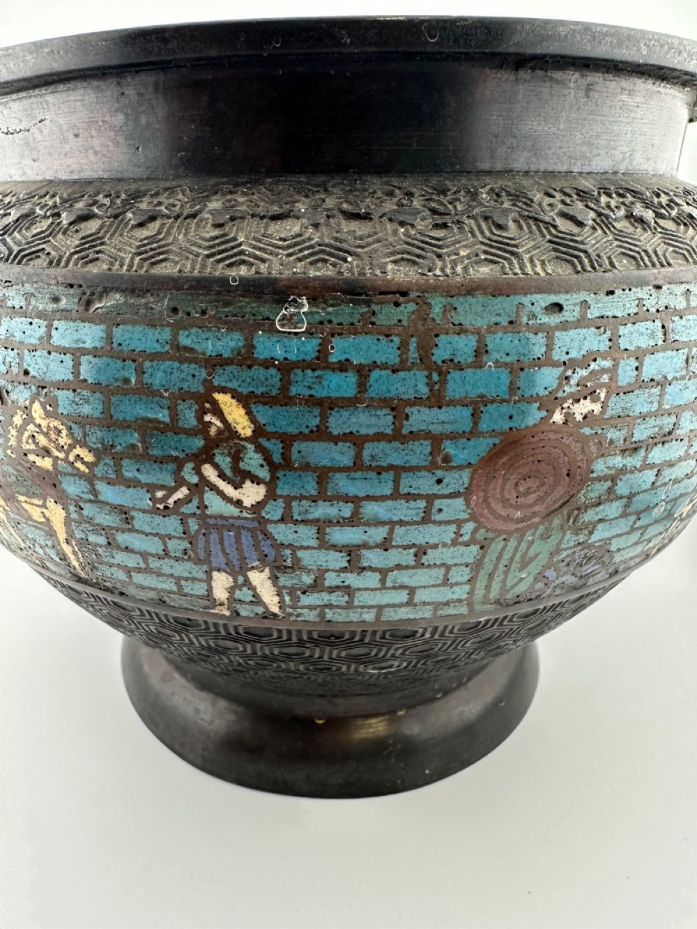 A pair of round dark bronze cachepots featuring a wide band of turquoise champleve enamel decorated with Greco-Roman figures. View II