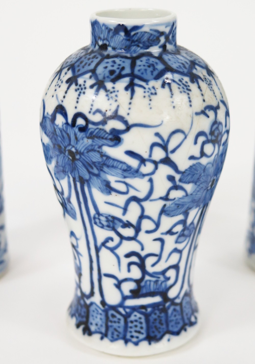 A set of three 19th-century Chinese blue and white porcelain vases featuring hand-painted floral motifs and figurative scenes. View V