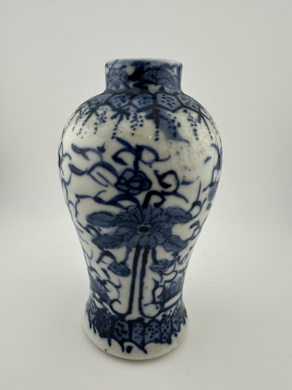 A set of three 19th-century Chinese blue and white porcelain vases featuring hand-painted floral motifs and figurative scenes. View X