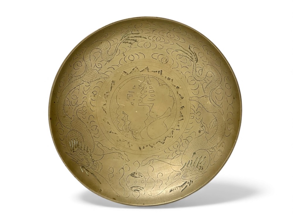 A circular shallow brass dish featuring detailed hand-engraved designs of dragons, clouds, and a central circular motif. View III