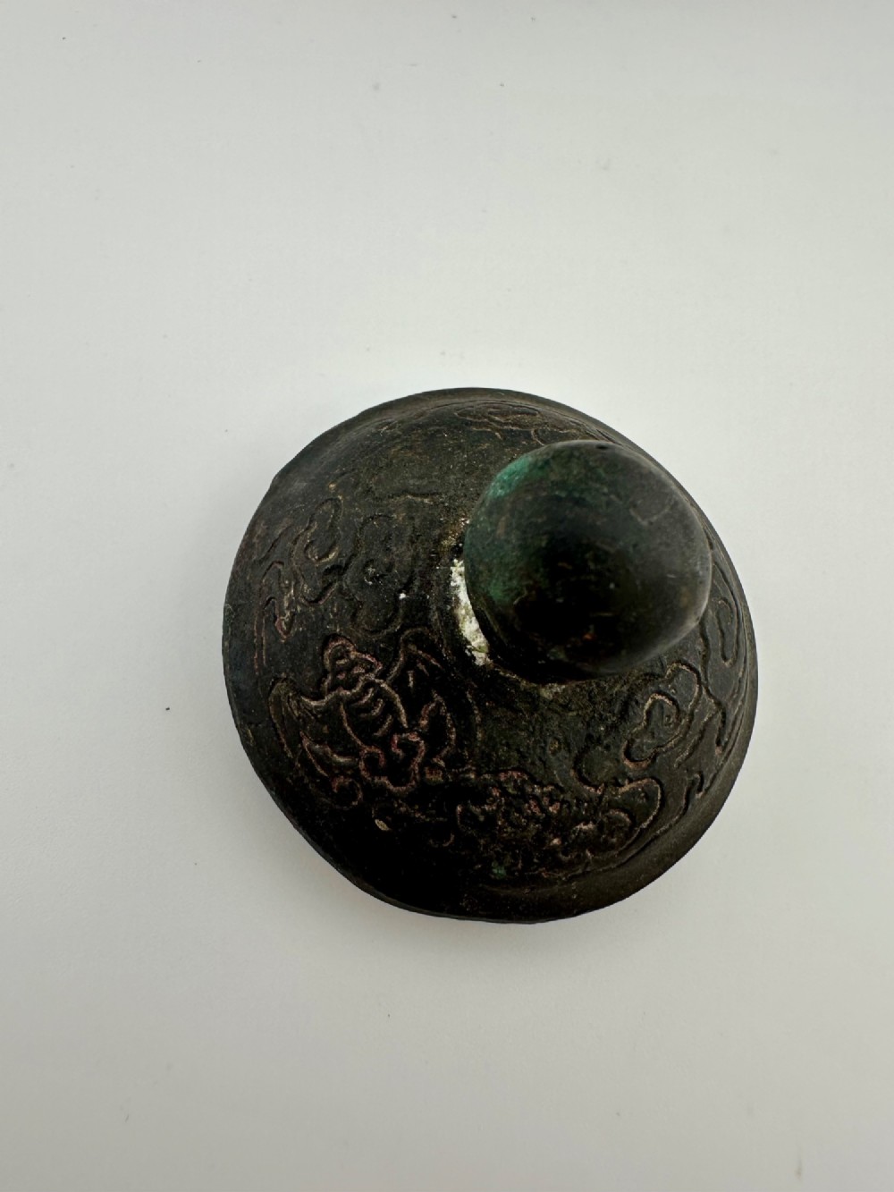 A dark cast bronze Chinese teapot featuring a sculpted dragon handle, a dragon-head spout, and raised Chinese character carvings on the main body. View V