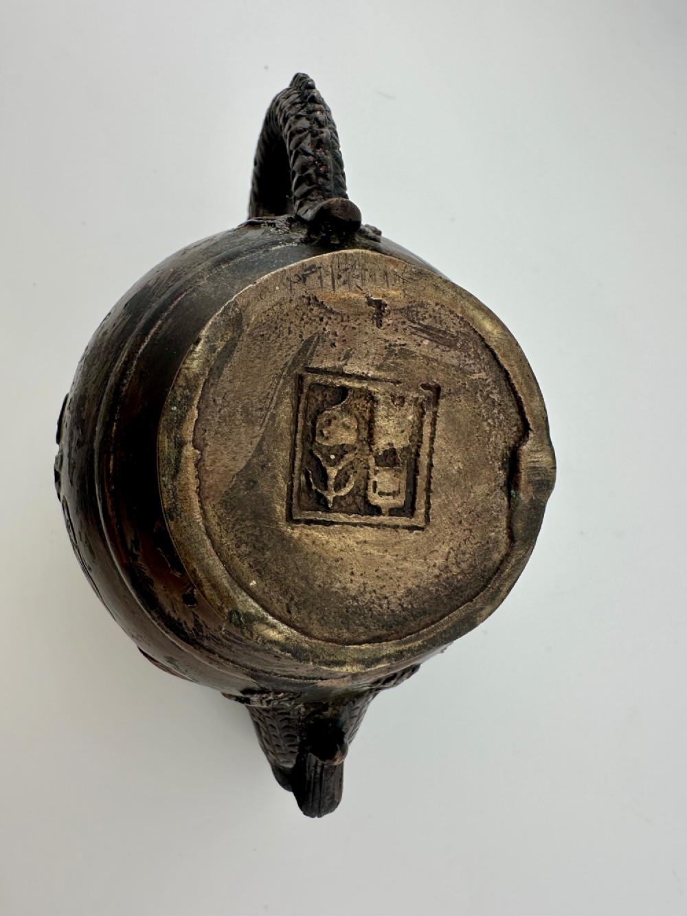 A dark cast bronze Chinese teapot featuring a sculpted dragon handle, a dragon-head spout, and raised Chinese character carvings on the main body. View IX
