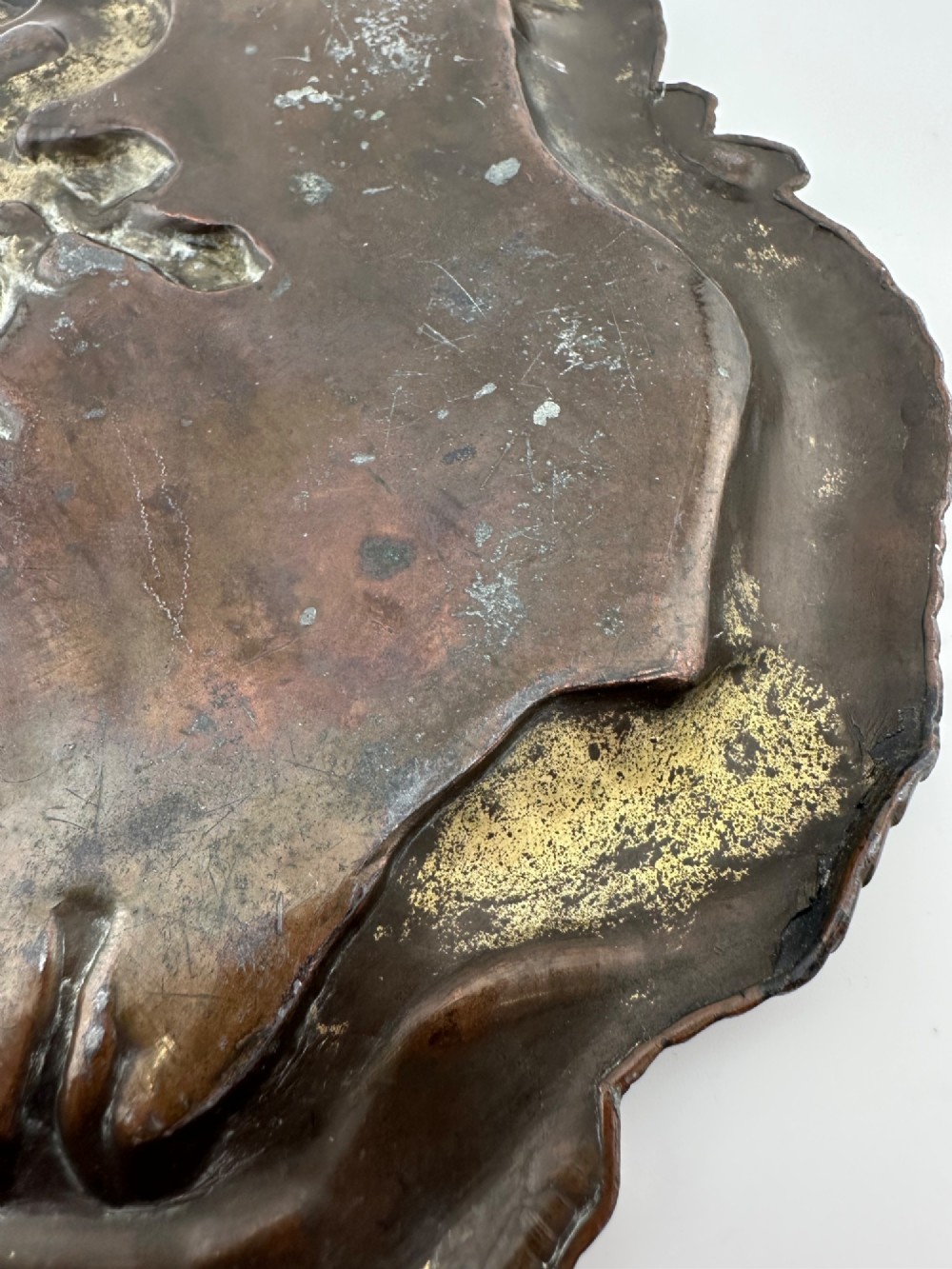 A dark patinated metal tray featuring a raised relief carving of a Japanese dragon coiling around its organic rim. View III