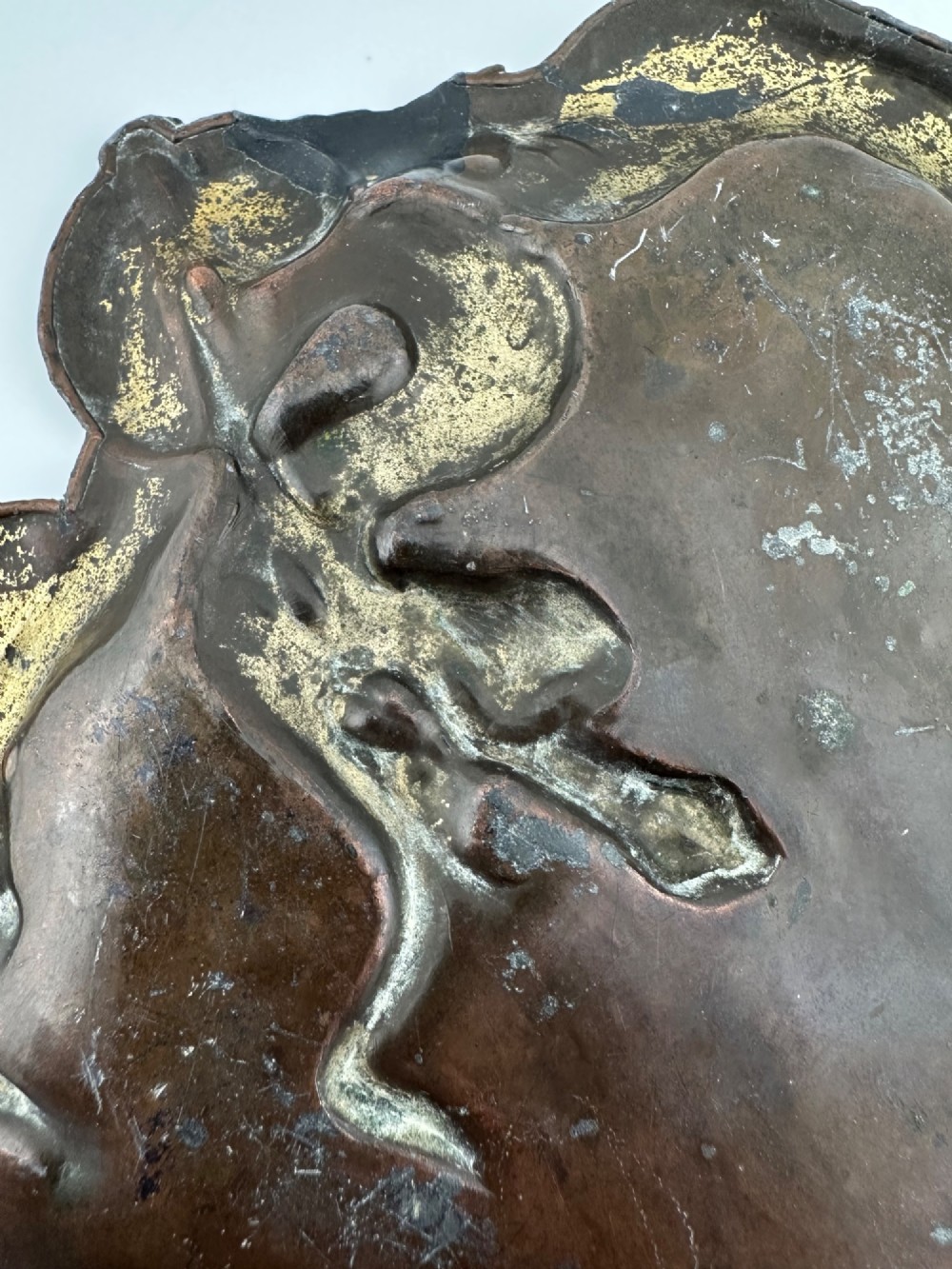A dark patinated metal tray featuring a raised relief carving of a Japanese dragon coiling around its organic rim. View IV