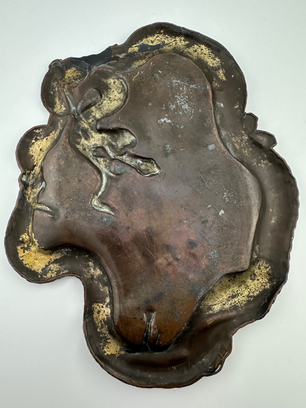 A dark patinated metal tray featuring a raised relief carving of a Japanese dragon coiling around its organic rim. View V