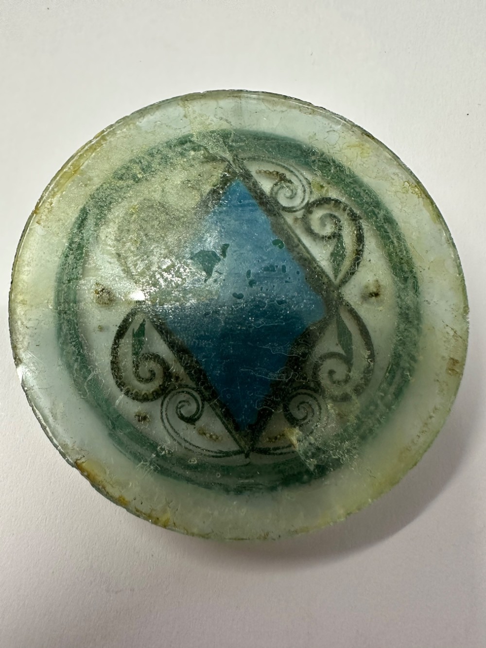 A circular glass Ottoman roundel featuring delicate gilt filigree scrollwork and a central diamond-shaped blue medallion with a calligraphic tughra. View III