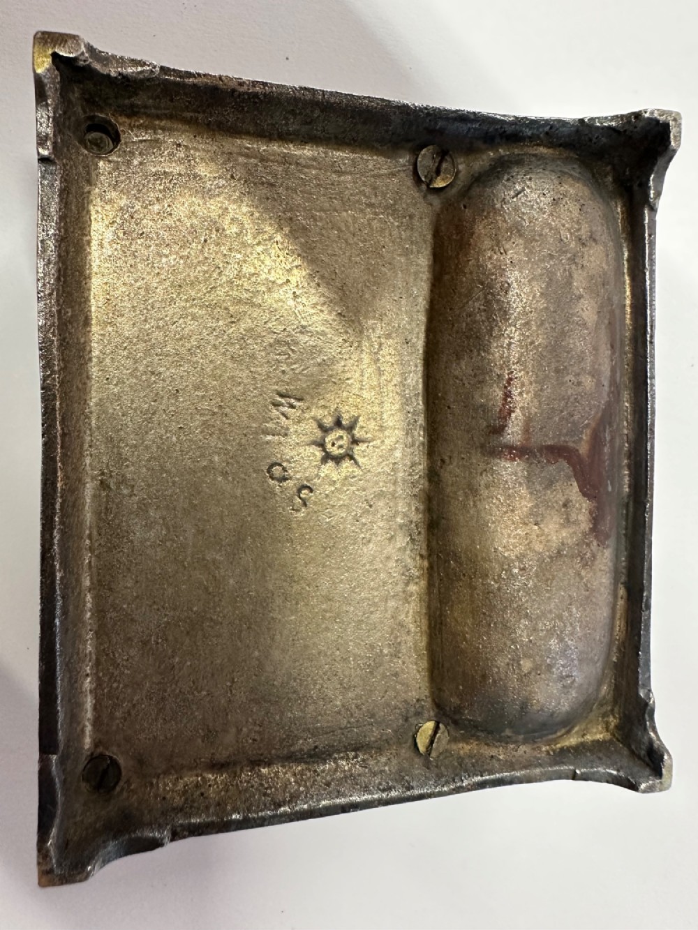 An antique silvered brass desktop vesta box with a hinged floral embossed lid, ribbed striker strip, and front tray resting on a beaded base. View VII