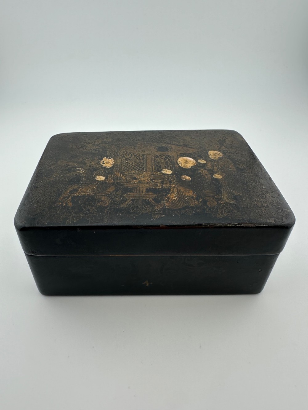 An early 19th-century rectangular black lacquer box with gilded painted Chinese figural scenes on the lid. View III