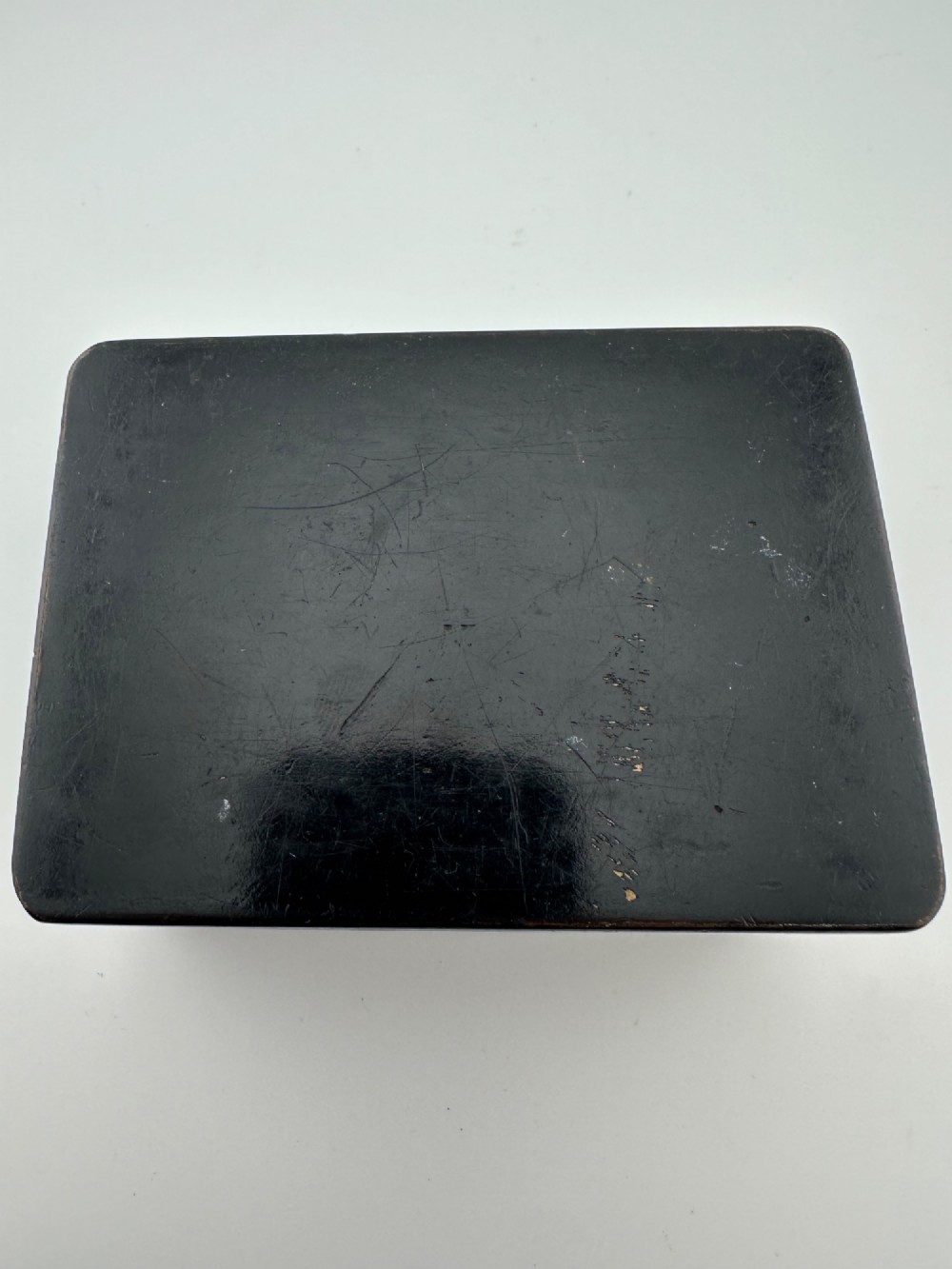 An early 19th-century rectangular black lacquer box with gilded painted Chinese figural scenes on the lid. View VII