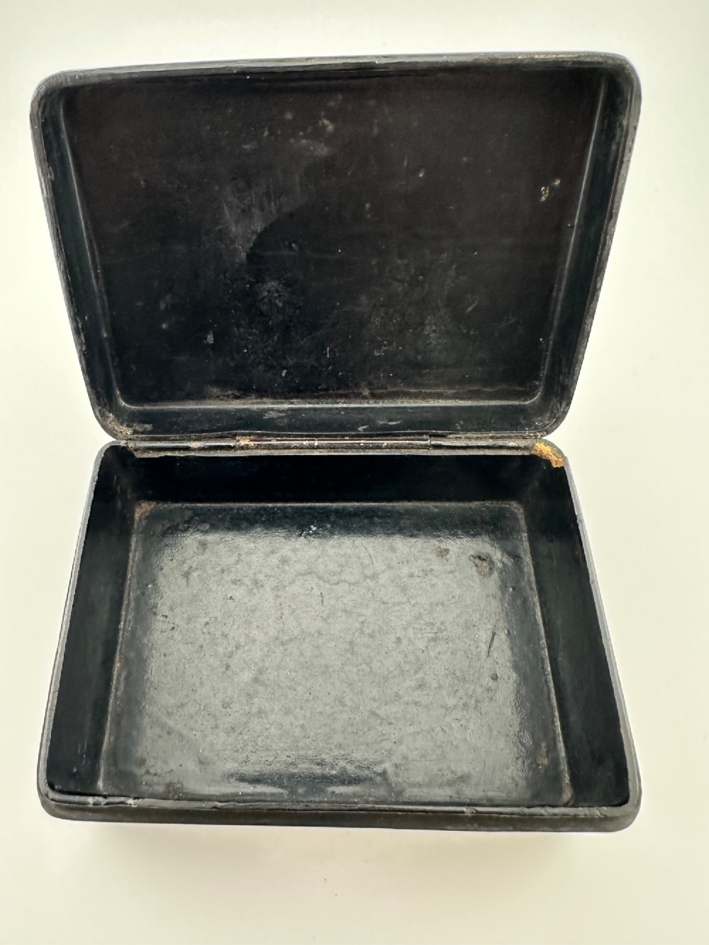 An early 19th-century rectangular black lacquer box with gilded painted Chinese figural scenes on the lid. View IX