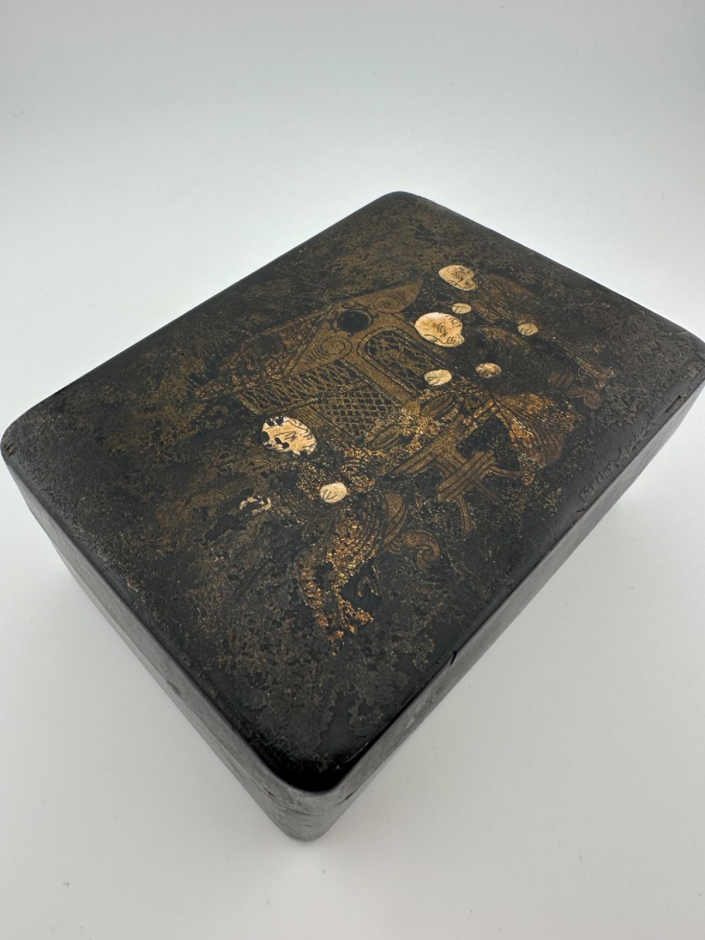 An early 19th-century rectangular black lacquer box with gilded painted Chinese figural scenes on the lid. View XII