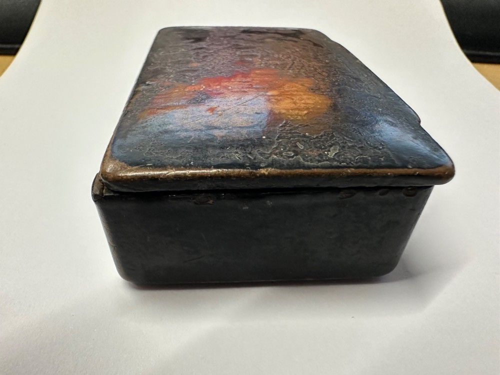 A small rectangular mid-19th-century Chinese export black lacquer box with a gilded decorated lid showing surface age and patina. View III