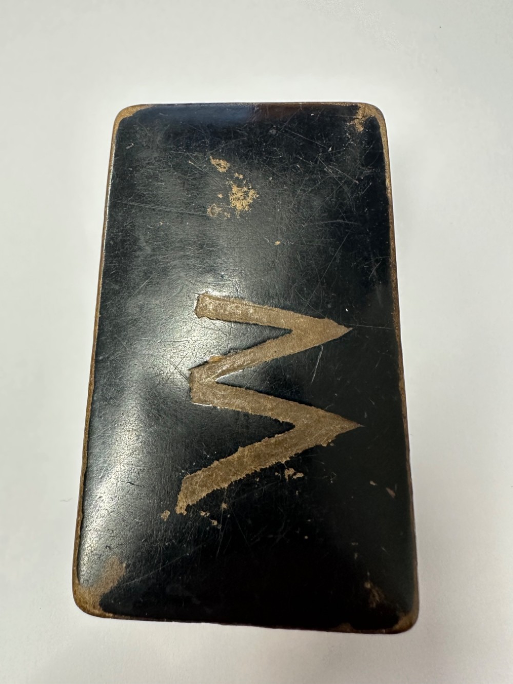 A small rectangular mid-19th-century Chinese export black lacquer box with a gilded decorated lid showing surface age and patina. View VII