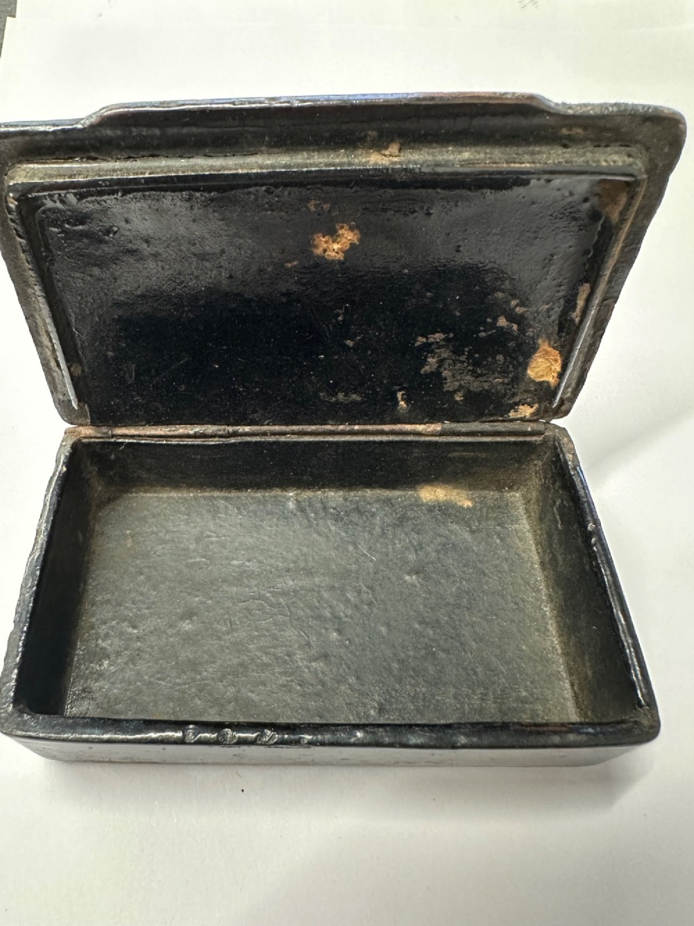 A small rectangular mid-19th-century Chinese export black lacquer box with a gilded decorated lid showing surface age and patina. View VIII