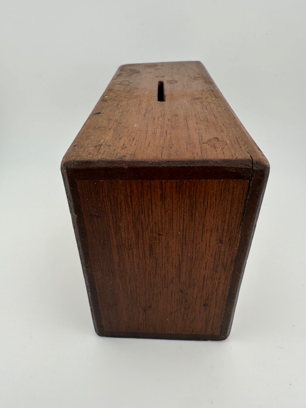 A rectangular dark wooden church collection box featuring a coin slot on top and a printed yellow and red Society for the Propagation of the Gospel label on the front. View VI