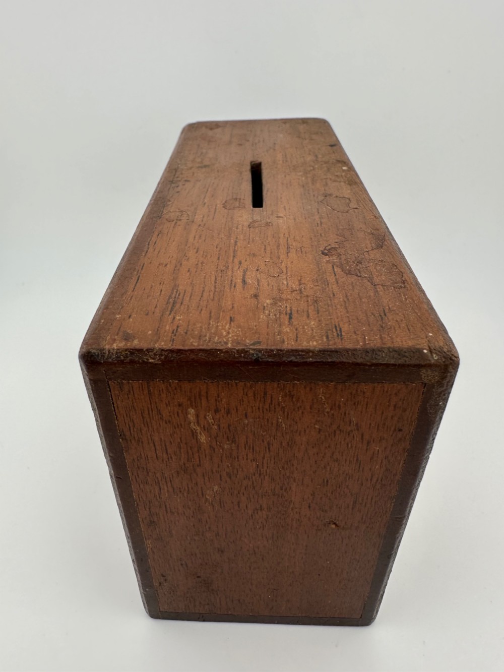 A rectangular dark wooden church collection box featuring a coin slot on top and a printed yellow and red Society for the Propagation of the Gospel label on the front. View VII