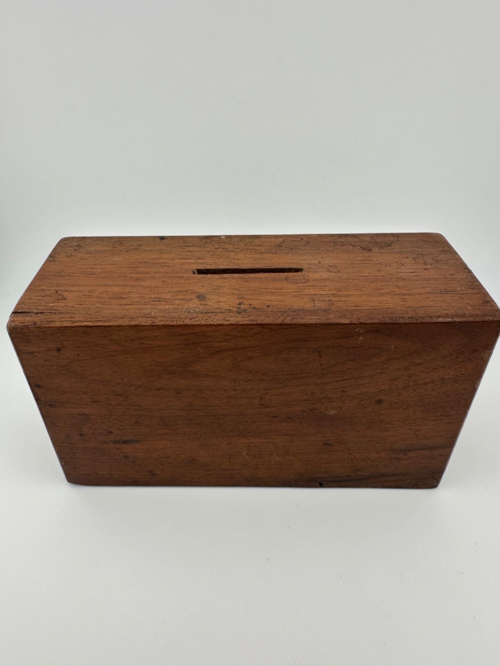A rectangular dark wooden church collection box featuring a coin slot on top and a printed yellow and red Society for the Propagation of the Gospel label on the front. View VIII