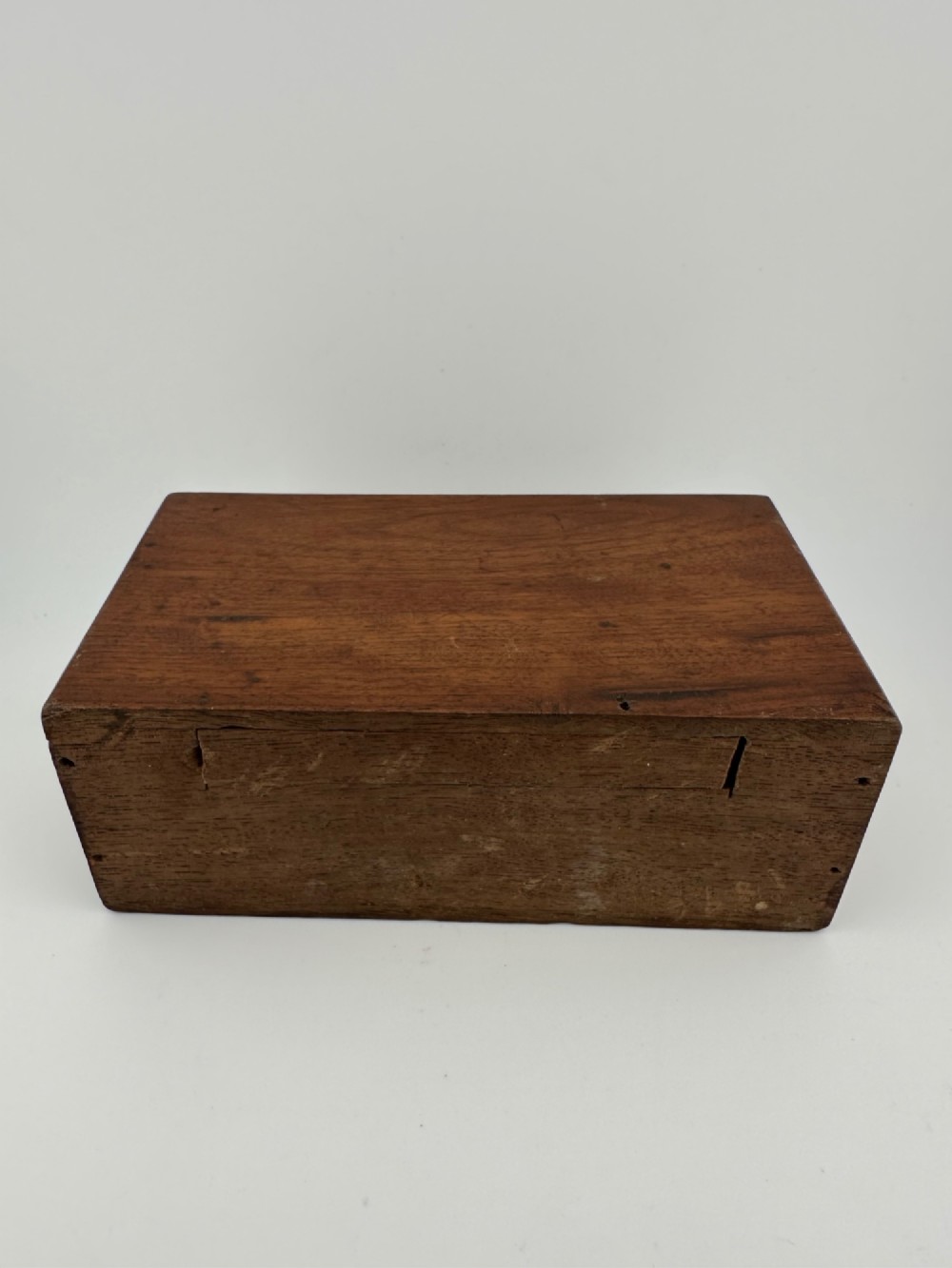 A rectangular dark wooden church collection box featuring a coin slot on top and a printed yellow and red Society for the Propagation of the Gospel label on the front. View IX