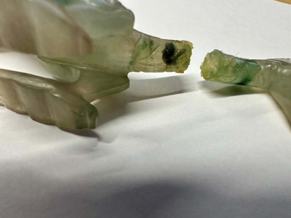 A carved pale green jade dragon sculpture shown alongside a dark pierced hardwood display stand. View VII