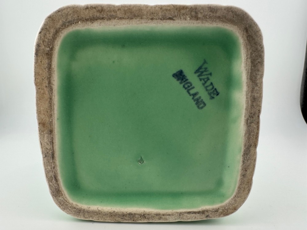 A pale green glazed earthenware Art Deco ceramic jug featuring relief brickwork and a sculpted bird perched on the handle. View V
