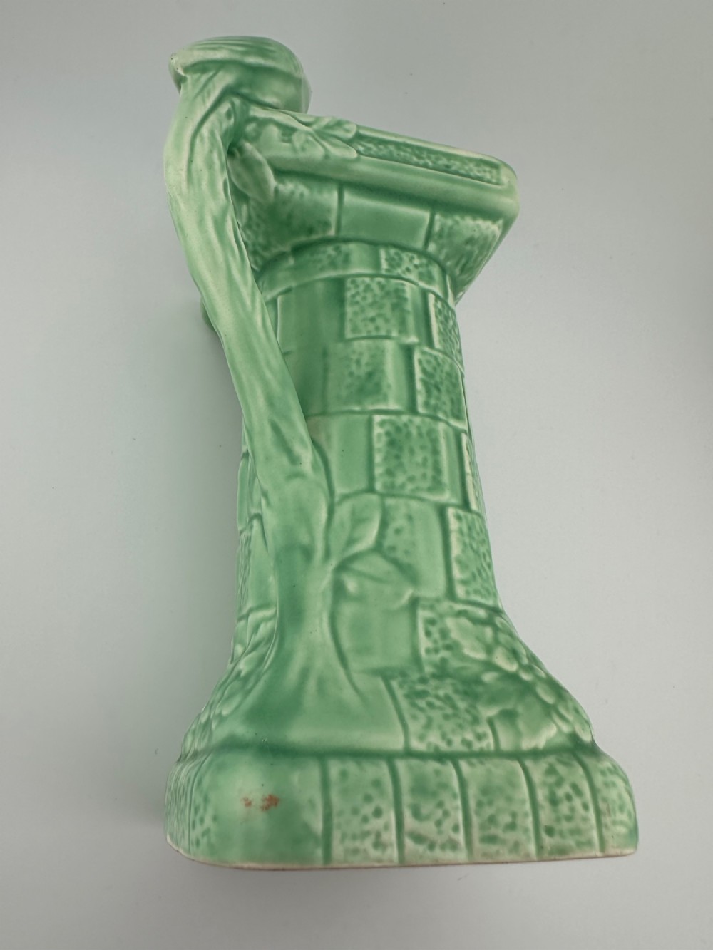 A pale green glazed earthenware Art Deco ceramic jug featuring relief brickwork and a sculpted bird perched on the handle. View VII