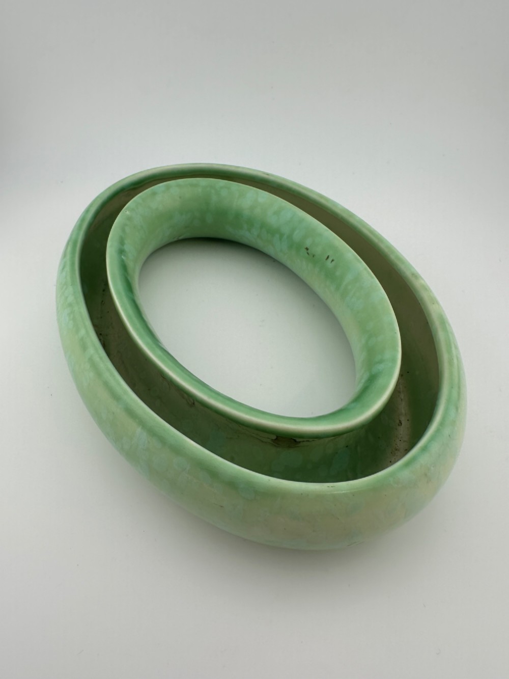 A 1930s oval ceramic posy ring vase with a mottled green glaze, featuring a hollow ring trough designed for short floral stems. View II