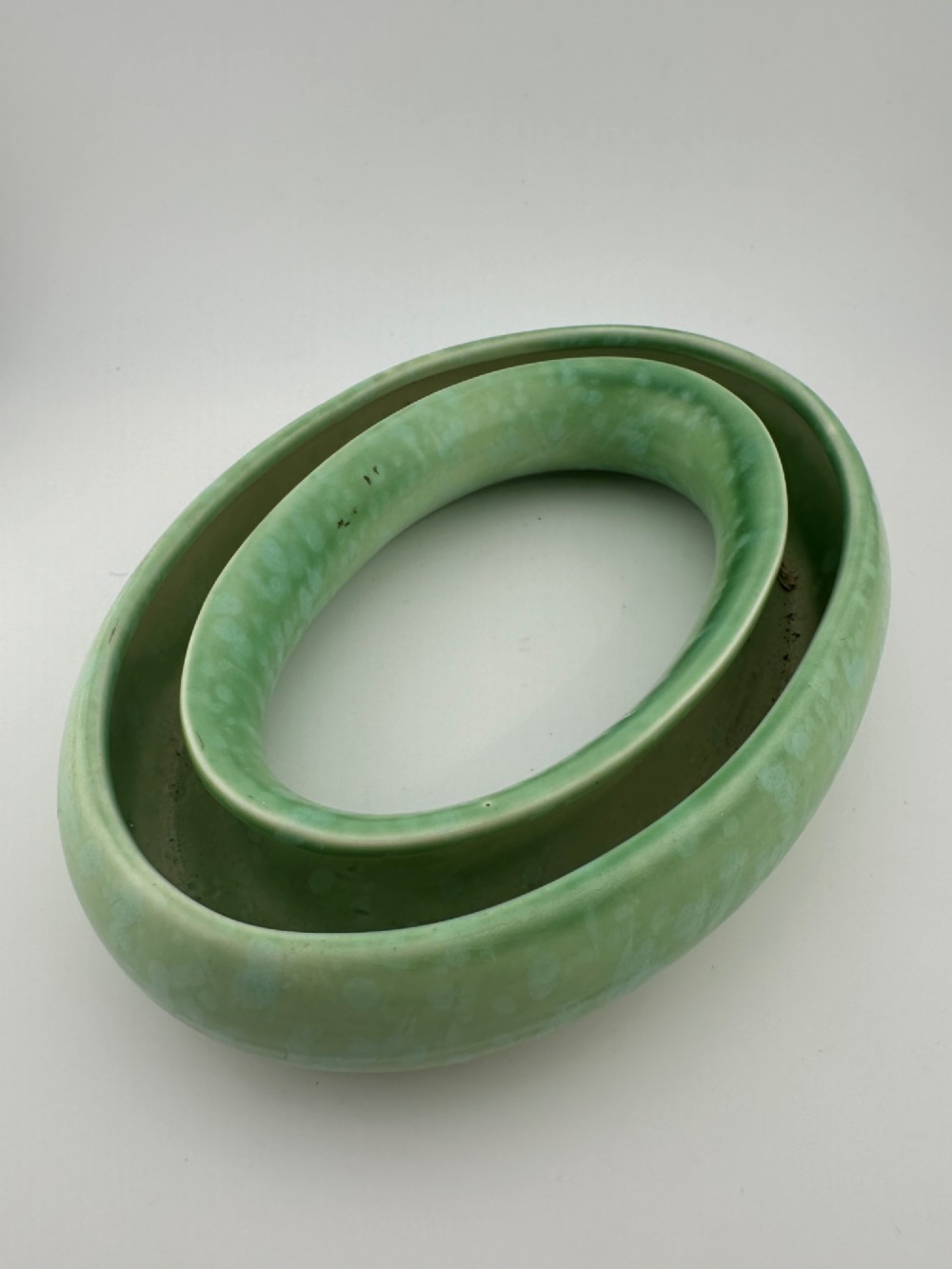 A 1930s oval ceramic posy ring vase with a mottled green glaze, featuring a hollow ring trough designed for short floral stems. View III