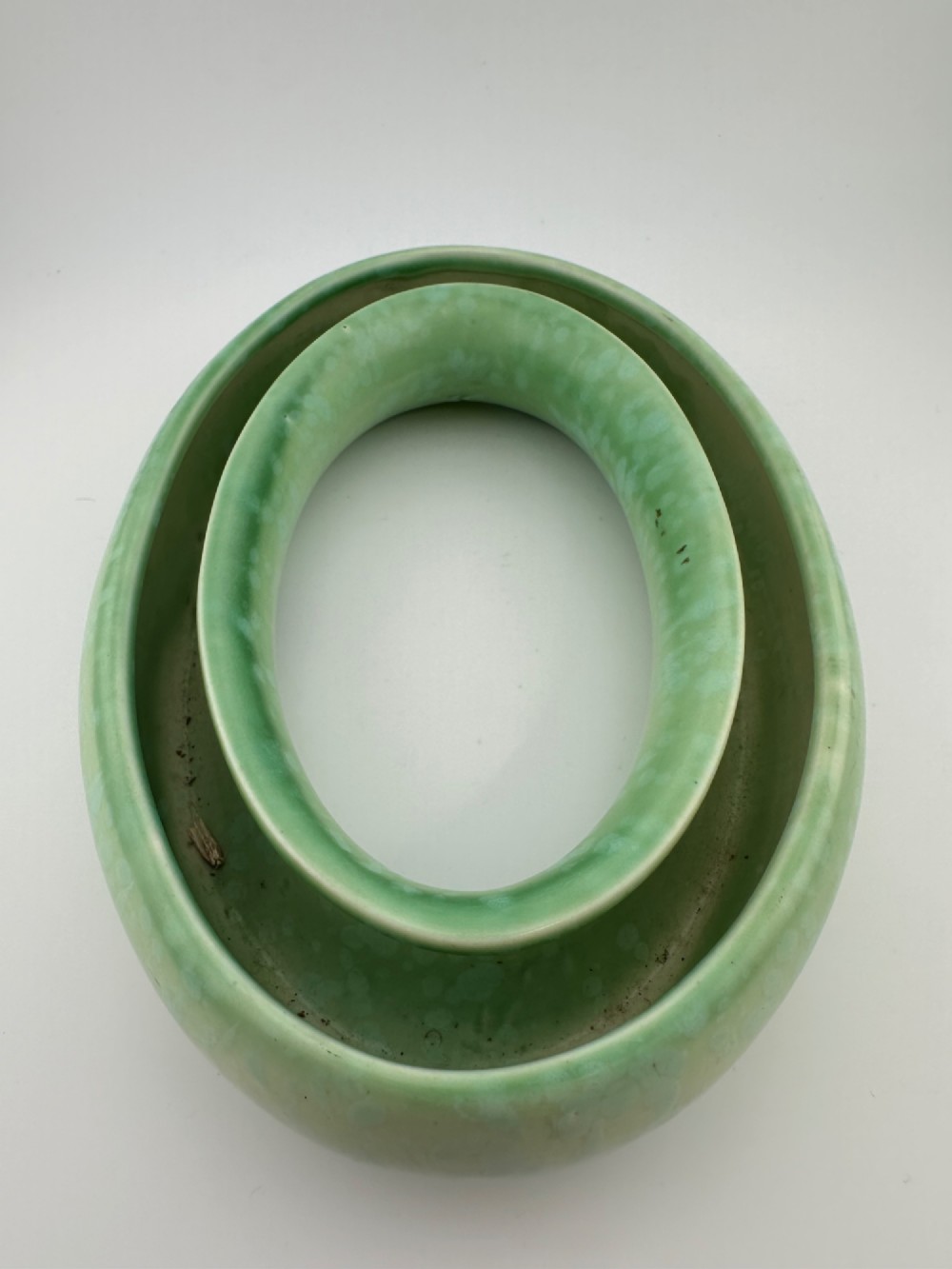 A 1930s oval ceramic posy ring vase with a mottled green glaze, featuring a hollow ring trough designed for short floral stems. View IV