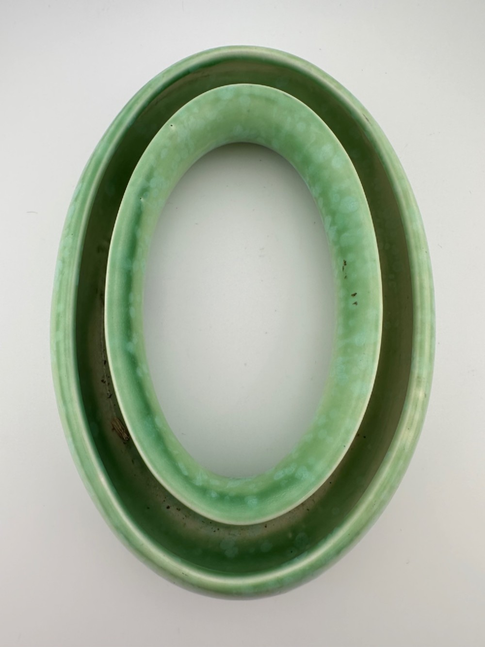 A 1930s oval ceramic posy ring vase with a mottled green glaze, featuring a hollow ring trough designed for short floral stems. View V