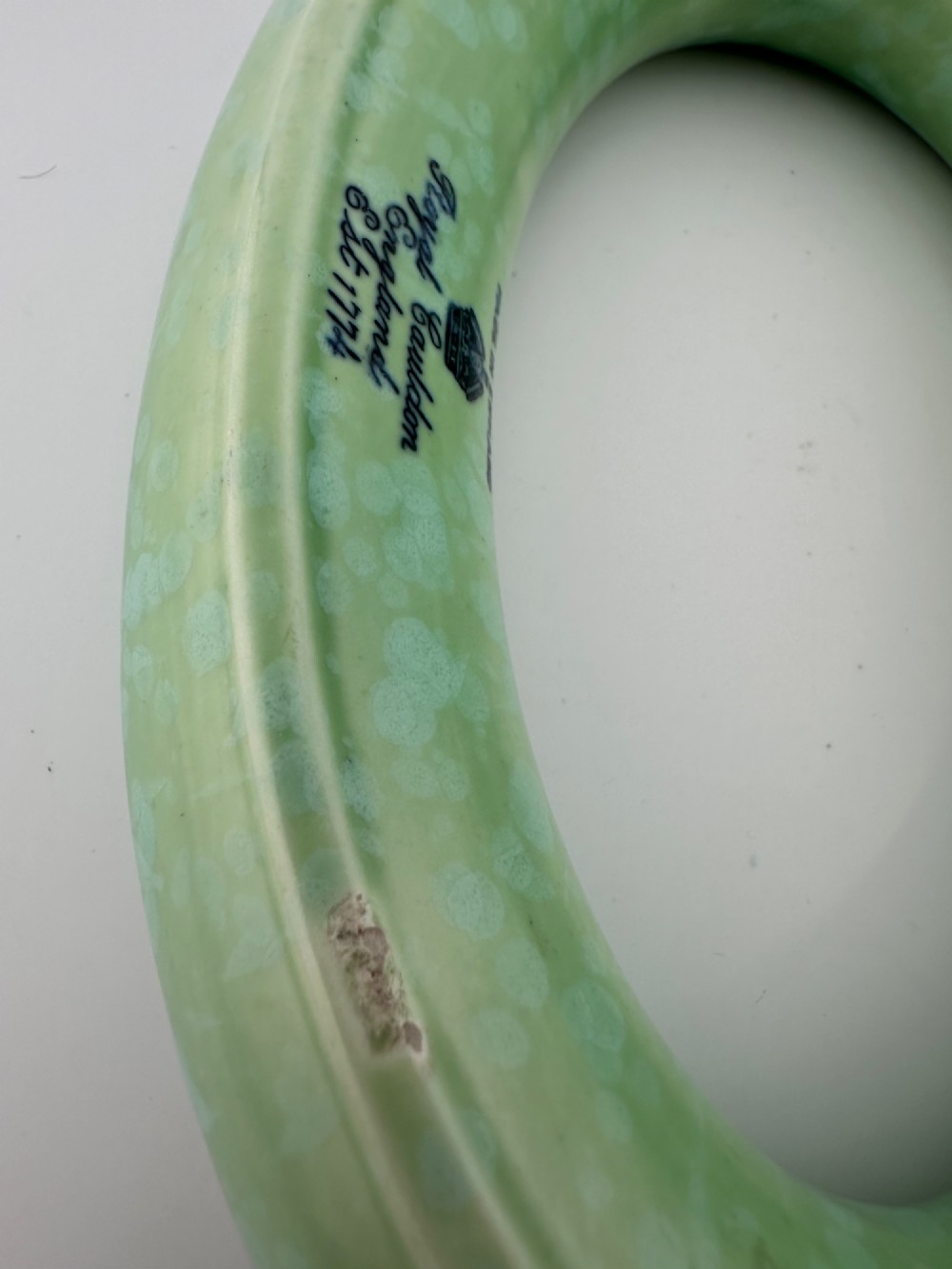 A 1930s oval ceramic posy ring vase with a mottled green glaze, featuring a hollow ring trough designed for short floral stems. View VIII