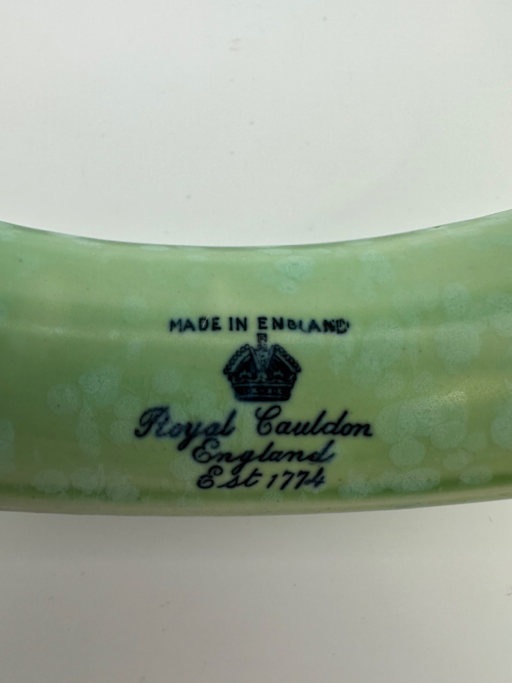 A 1930s oval ceramic posy ring vase with a mottled green glaze, featuring a hollow ring trough designed for short floral stems. View X