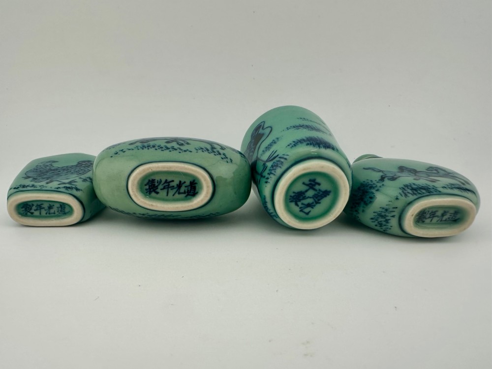 A set of four celadon-green porcelain snuff bottles painted with underglaze blue depictions of horses and birds. View VI