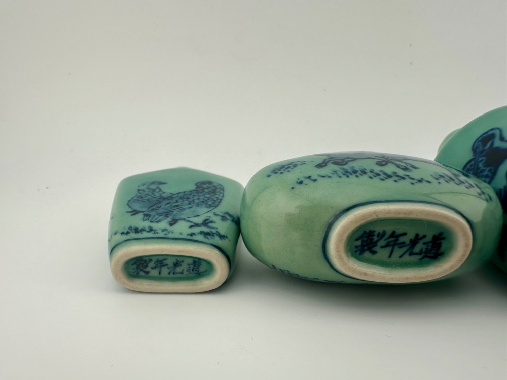A set of four celadon-green porcelain snuff bottles painted with underglaze blue depictions of horses and birds. View VII