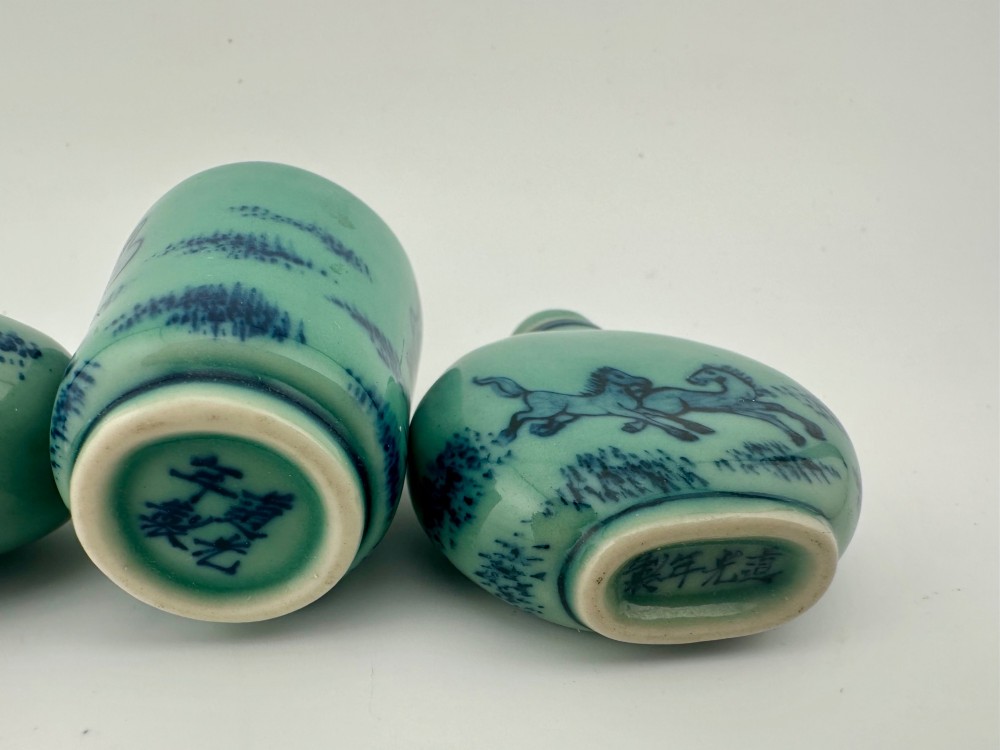 A set of four celadon-green porcelain snuff bottles painted with underglaze blue depictions of horses and birds. View VIII