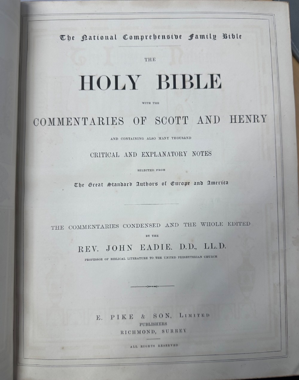A dark leather-bound Victorian Holy Bible featuring gilt lettering inside a star-shaped frame and decorative brass corner mounts. View IX