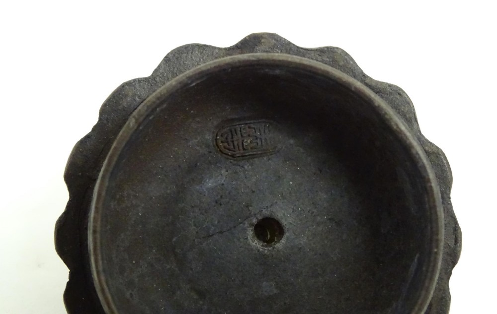 A small dark brown unglazed ceramic teapot featuring a lobed body and a bird-shaped finial on the lid. View VII